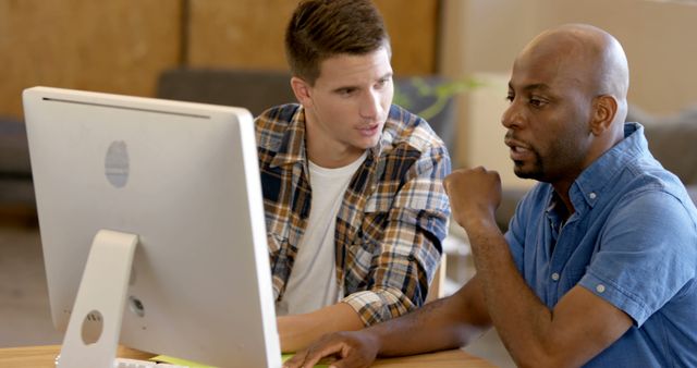 Multiracial Colleagues Discussing Project on Desktop Computer in Office - Download Free Stock Images Pikwizard.com