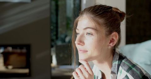 Peaceful Woman Relaxing in Sunlit Home Interior - Download Free Stock Images Pikwizard.com