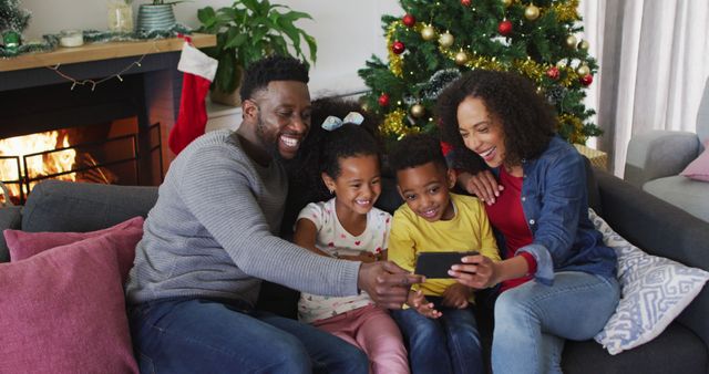 Happy Family Spending Christmas Together Watching Video on Smartphone - Download Free Stock Images Pikwizard.com