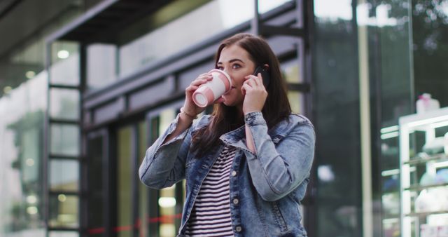 Woman Drinking Coffee While Talking on Phone in Urban Setting - Download Free Stock Images Pikwizard.com