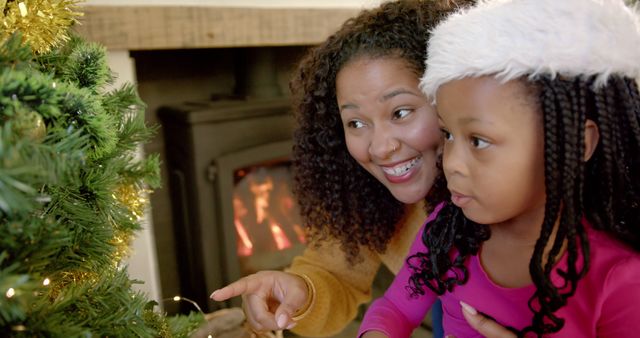 African American Mother and Daughter Enjoying Christmas Tree Decoration - Download Free Stock Images Pikwizard.com