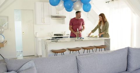 Couple Preparing Home for Celebration with Balloons