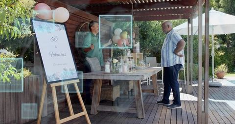Planning 60th birthday celebration under pergola with elegant tablescape and balloons