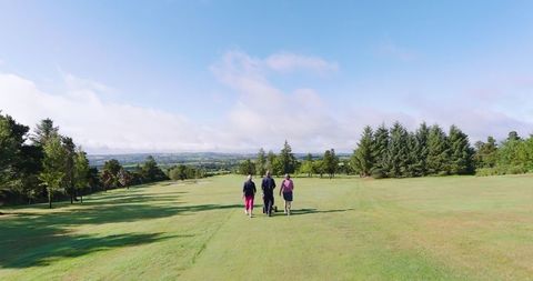 Seniors Enjoying Golf Stroll on Scenic Fairway