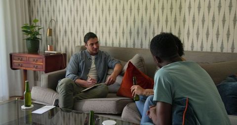 Friends Gathering at Home for Relaxed Conversation and Drinks