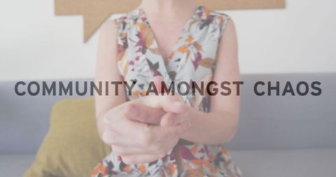 Woman Sanitizing Hands in Office Against Blurred Background