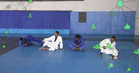 Martial artists stretching in gis on blue mats with green network icons and teamwork tech