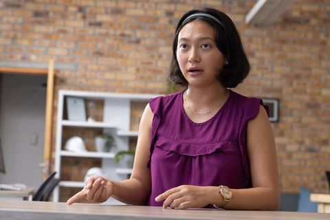 Focused Asian Businesswoman in Modern Industrial Workspace