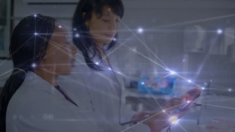 Diverse Female Scientists Analyzing Digital Connections in Laboratory