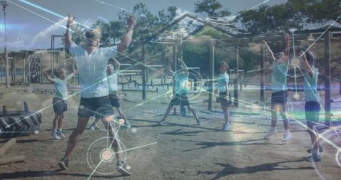 Children performing star jumps in outdoor exercise class with digital network overlay