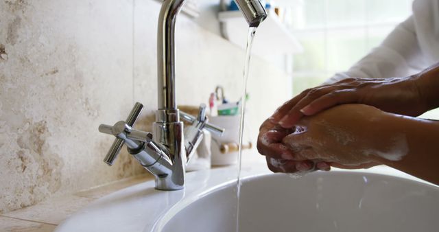 Person Washing Hands Under Running Water in Bathroom - Download Free Stock Images Pikwizard.com