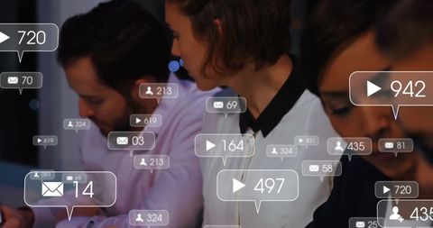 Diverse team receiving social media notifications at work