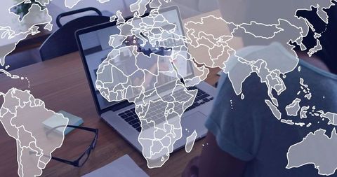 Remote teamwork and focus at home workspace with laptop, glasses, notes and translucent world map ov