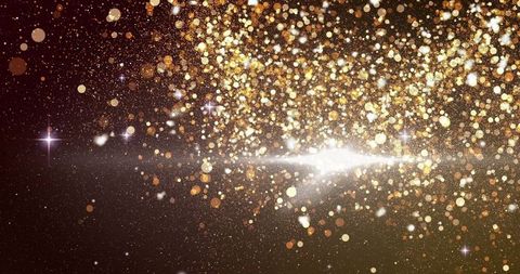 Golden bokeh and light over dark background