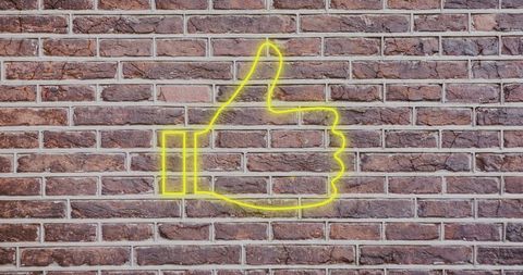 Glowing Yellow Thumbs Up on Rustic Brick Wall - Download Free Stock Images Pikwizard.com