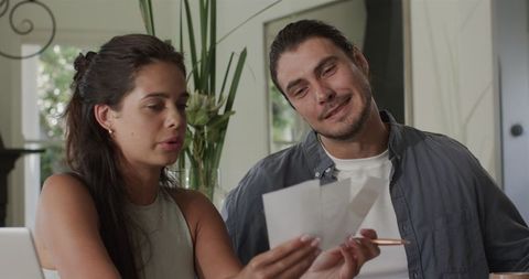 Couple Having Lighthearted Conversation in Modern Kitchen