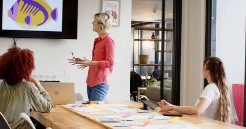 Diverse Team Collaborating in Modern Office on Visual Presentation