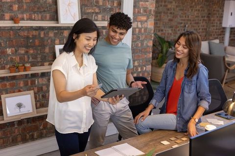 Diverse Team Collaborating in Modern Office with Tablet Technology