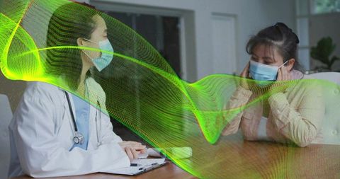 Doctor consulting patient wearing medical masks with green digital wave illustrating airflow