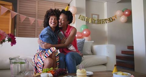 Diverse Female Couple Joyfully Celebrating Birthday at Home