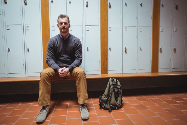 Portrait of mature student sitting in the locker room at college