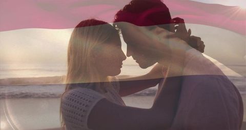 Sunset Embrace on Beach with Romantic Couple and Subtle Flag Overlay Backlit Silhouette