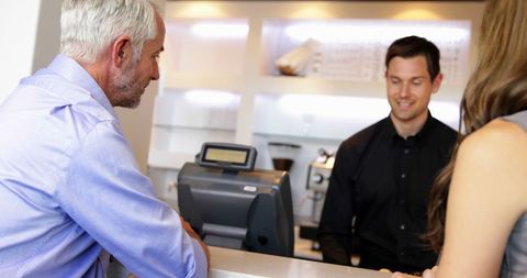 Bartender Engages Customers at Trendy Local Bar Counter