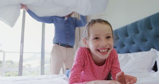 Father and Daughter Having Fun Pillow Fight in Bedroom - Download Free Stock Images Pikwizard.com