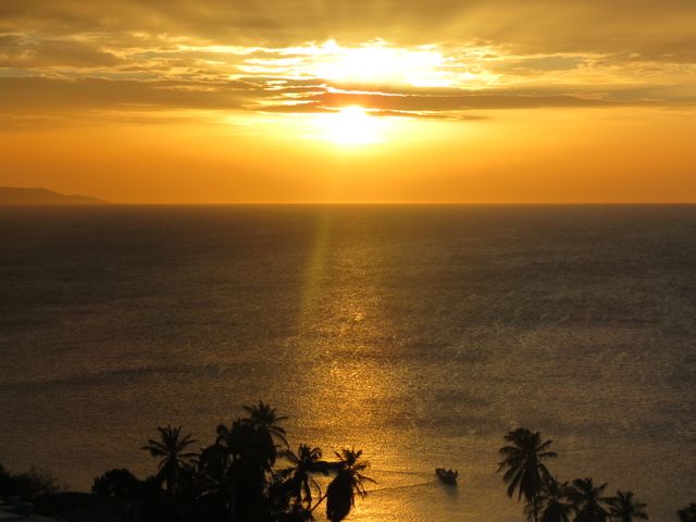 Golden Sunset Over Tropical Ocean with Silhouetted Boat and Palm Trees - Download Free Stock Photos Pikwizard.com