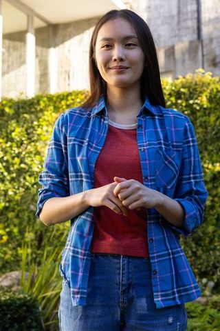 Young Asian Woman Relaxing in Casual Chic Outdoor Style