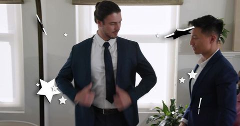 Adjusting navy suit jacket during business meeting showing confident professional team