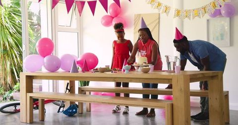 Family Organizing Birthday Party with Decorations