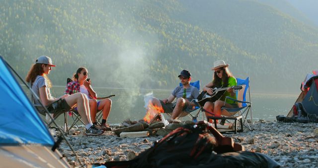 Camping Friends Enjoying Campfire and Guitar by Lake - Download Free Stock Images Pikwizard.com