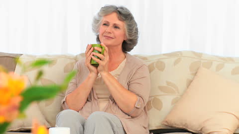 Senior Woman Enjoying Relaxing Tea Time at Home