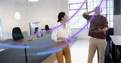 Coworking reception team discussing with tablets and neon motion streaks
