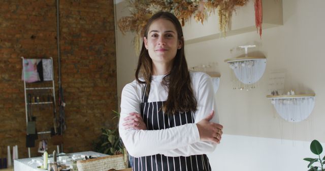 Confident Female Artisan in Apron with Folded Arms Inside Studio - Download Free Stock Images Pikwizard.com