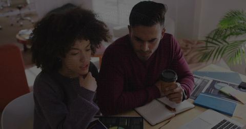 Focused Coworkers Reviewing Data on Tablet in Office