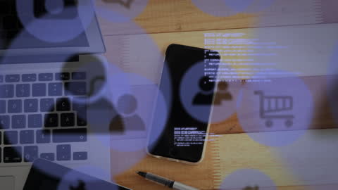 Digital Icons Hovering Over Smartphone and Laptop on Wooden Table