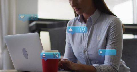 Professional Woman Typing on Laptop in Cafe with Social Media Notifications and Coffee Cup