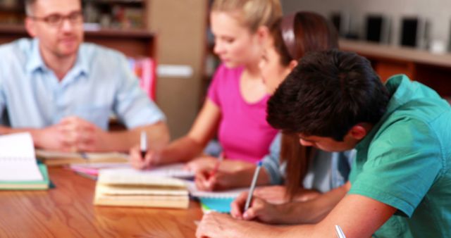 Group of Young Students Collaborating on Study Project in Library - Download Free Stock Images Pikwizard.com