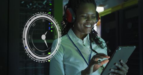 African American Woman Enjoying Tablet in Server Room with Digital Clock Overlay - Download Free Stock Images Pikwizard.com