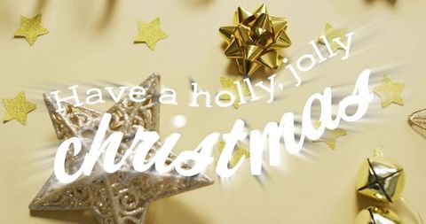 Holly jolly christmas greeting in white script over gold ornaments and silver star