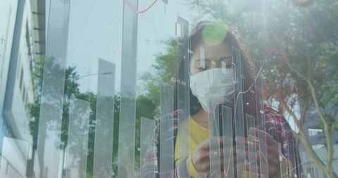 Business analyst wearing mask analyzing data on digital graph