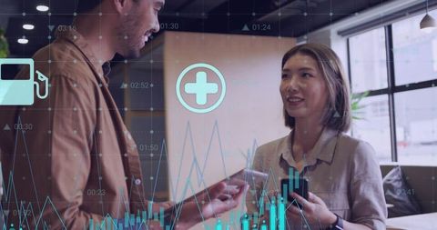 Business professionals exchanging card and phone with data hud overlays in coworking space