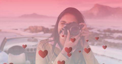 Woman Taking Photograph Near Cabriolet with Heart Overlays