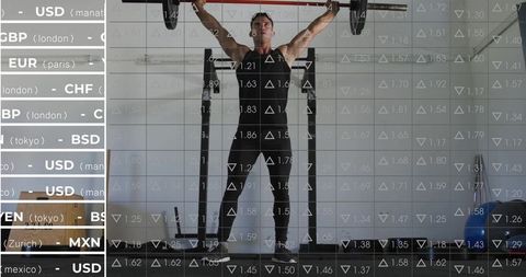 Male athlete pressing overhead barbell in gym with financial market overlay and data grid
