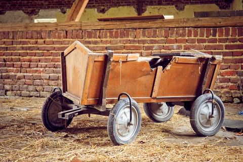 Rustic wooden cart abandoned in barn