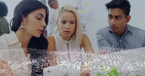 Focused team collaborating on digital data in modern office