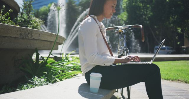 Businesswoman Working Outdoors with Laptop Near Fountain - Download Free Stock Images Pikwizard.com