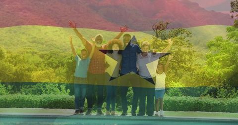 Ghanaian multigenerational family raising arms by backyard pool with ghana flag overlay